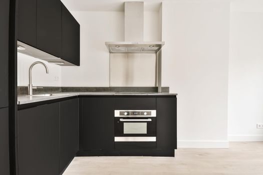 Well-organized interior of a small home kitchen with a black kitchen set