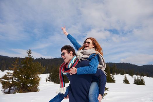 romantic winter  scene, happy young couple having fun on fresh show on winter vacatio, mountain nature landscape