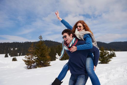 romantic winter  scene, happy young couple having fun on fresh show on winter vacatio, mountain nature landscape