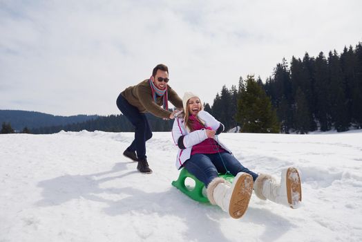 romantic winter  scene, happy young couple having fun on fresh show on winter vacatio, mountain nature landscape