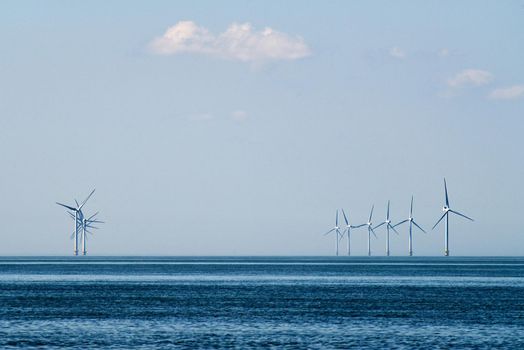 Tall white wind turbines in the distance