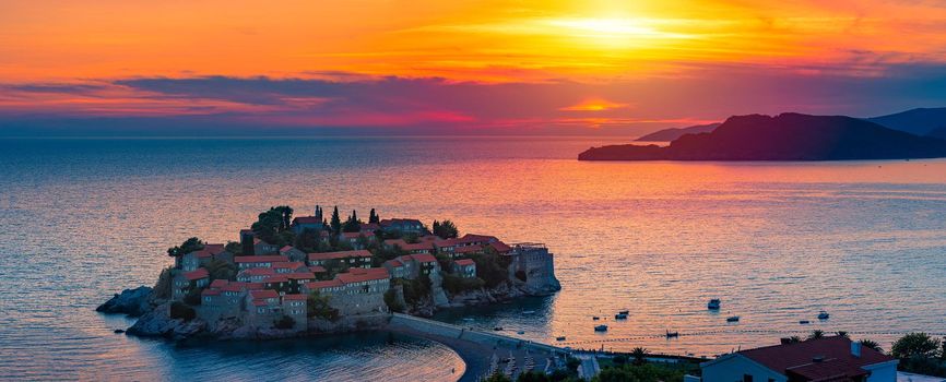 Panorama of Sveti Stefan island near Budva on a beautiful summer day at sunset. Montenegro, Balkans, Europe.