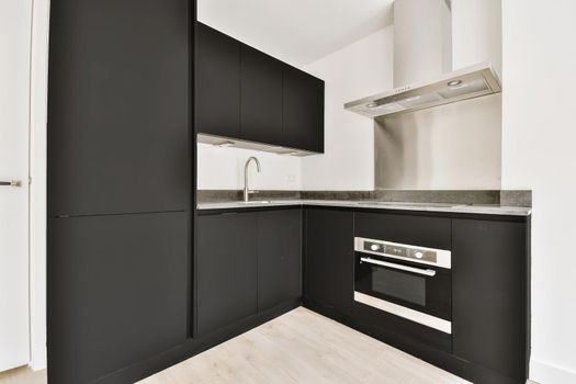 Well-organized interior of a small home kitchen with a black kitchen set