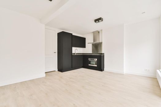 Well-organized interior of a small home kitchen with a black kitchen set