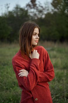 pretty woman in red sweater outdoors walk leisure. High quality photo