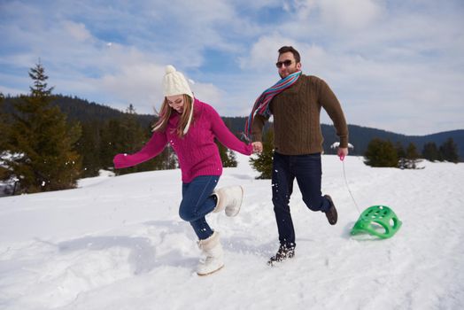 romantic winter  scene, happy young couple having fun on fresh show on winter vacatio, mountain nature landscape