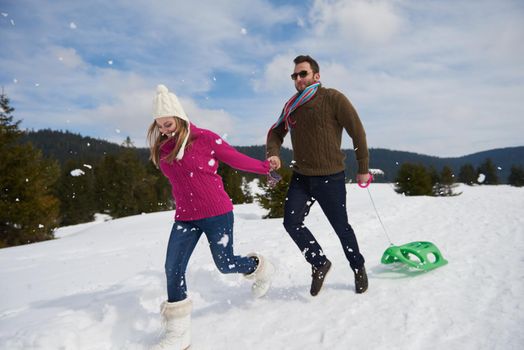 romantic winter  scene, happy young couple having fun on fresh show on winter vacatio, mountain nature landscape