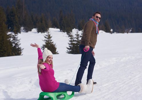 romantic winter  scene, happy young couple having fun on fresh show on winter vacatio, mountain nature landscape