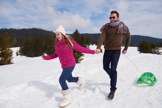 romantic winter  scene, happy young couple having fun on fresh show on winter vacatio, mountain nature landscape