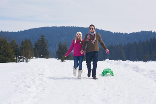 romantic winter  scene, happy young couple having fun on fresh show on winter vacatio, mountain nature landscape