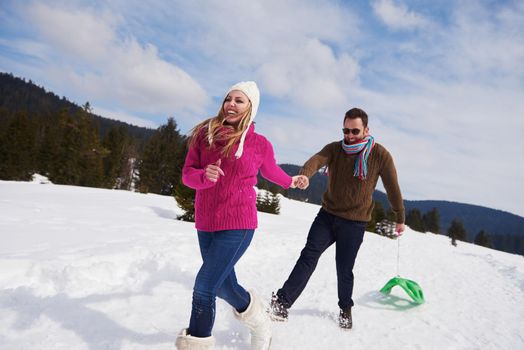 romantic winter  scene, happy young couple having fun on fresh show on winter vacatio, mountain nature landscape