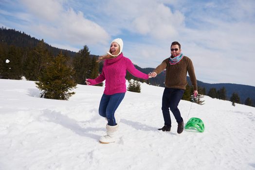 romantic winter  scene, happy young couple having fun on fresh show on winter vacatio, mountain nature landscape