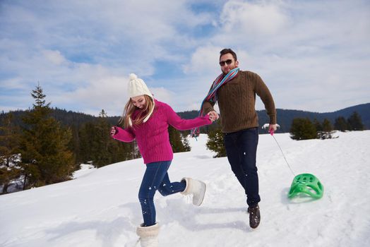 romantic winter  scene, happy young couple having fun on fresh show on winter vacatio, mountain nature landscape