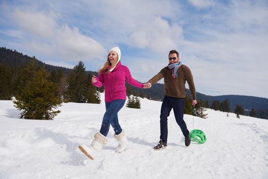 romantic winter  scene, happy young couple having fun on fresh show on winter vacatio, mountain nature landscape