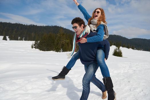 romantic winter  scene, happy young couple having fun on fresh show on winter vacatio, mountain nature landscape