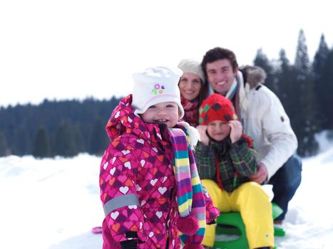 Winter playing, fun, snow and family portrait  sledding at winter time