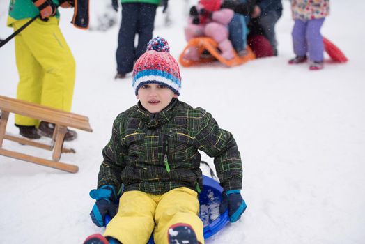 group of children having fun and play together in fresh snow on winter vacation