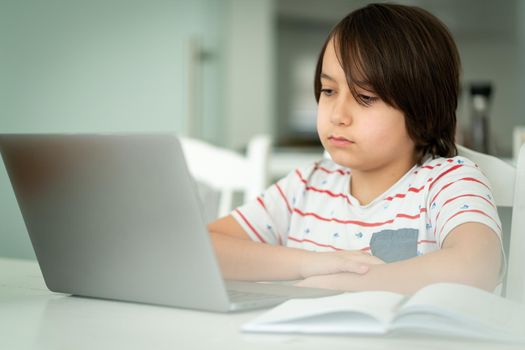 Child using laptop at home indoors. high quality photo