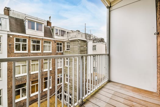 Pretty long narrow balcony with wooden white handrails