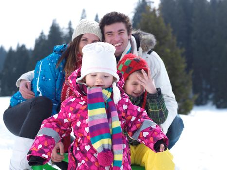 Winter playing, fun, snow and family portrait  sledding at winter time