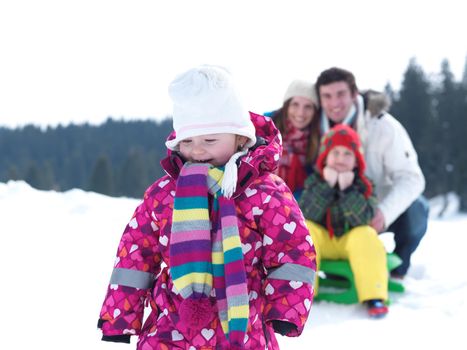 Winter playing, fun, snow and family portrait  sledding at winter time