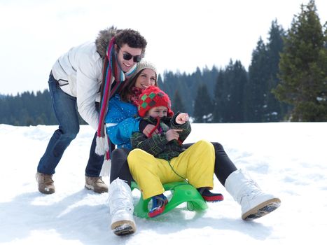 Winter playing, fun, snow and family portrait  sledding at winter time