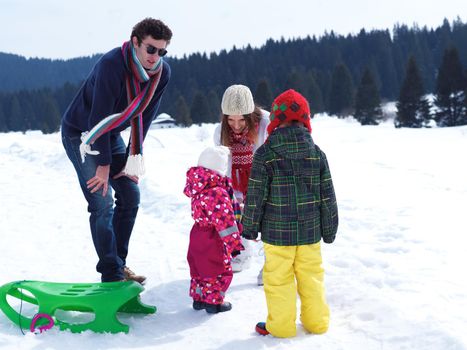 Winter playing, fun, snow and family portrait  sledding at winter time