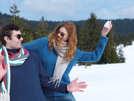 romantic winter  scene, happy young couple having fun on fresh show on winter vacatio, mountain nature landscape