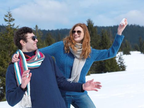 romantic winter  scene, happy young couple having fun on fresh show on winter vacatio, mountain nature landscape