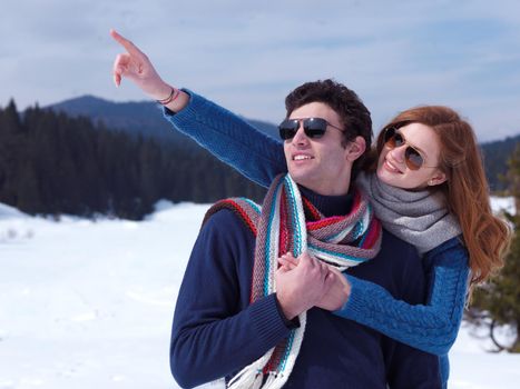 romantic winter  scene, happy young couple having fun on fresh show on winter vacatio, mountain nature landscape