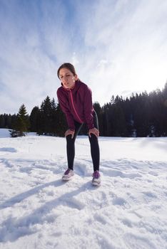 yougn woman jogging outdoor on snow in forest, healthy winter lifestyle and recreation