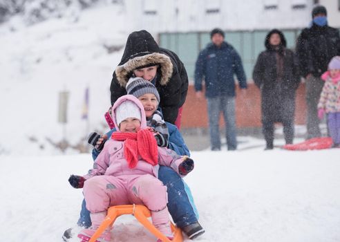 group of children having fun and play together in fresh snow on winter vacation