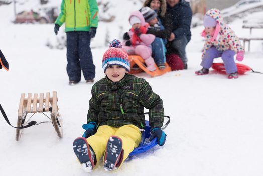 portrait of happy smiling little boy child outdoors having fun and playing on snowy winter day