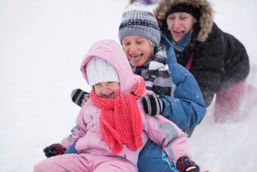 group of children having fun and play together in fresh snow on winter vacation