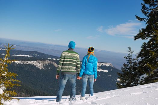 Young Couple In winter Snow Scene at  beautiful sunny day