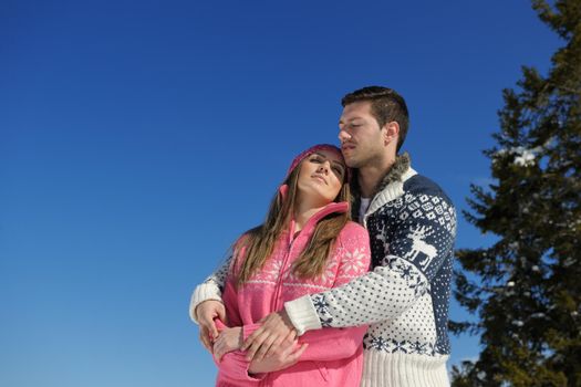 Young Couple In winter Snow Scene at  beautiful sunny day