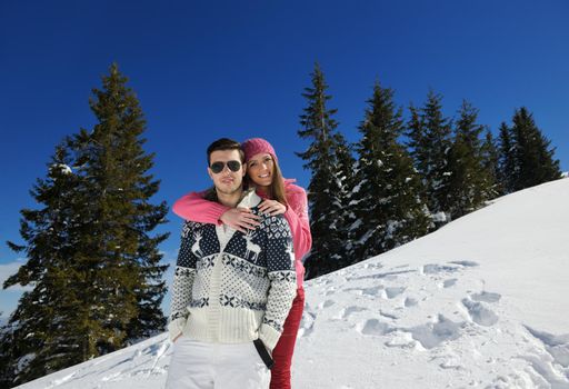 Young Couple In winter Snow Scene at  beautiful sunny day