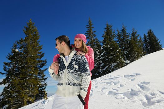 Young Couple In winter Snow Scene at  beautiful sunny day