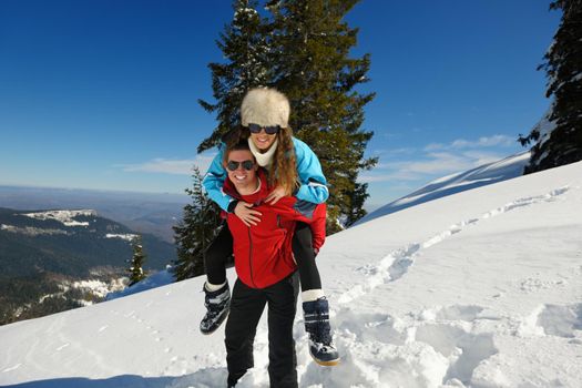 Young Couple In winter Snow Scene at  beautiful sunny day