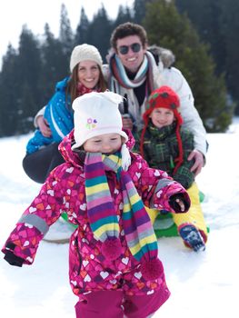 Winter playing, fun, snow and family portrait  sledding at winter time