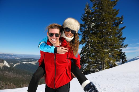 Young Couple In winter Snow Scene at  beautiful sunny day