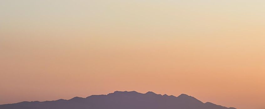Background from a beautiful colorful sunset with the silhouette of the mountains. High quality photo