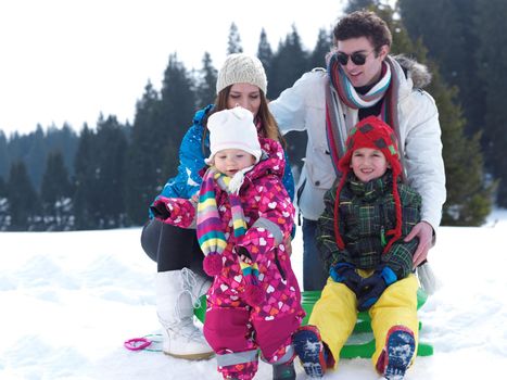 Winter playing, fun, snow and family portrait  sledding at winter time