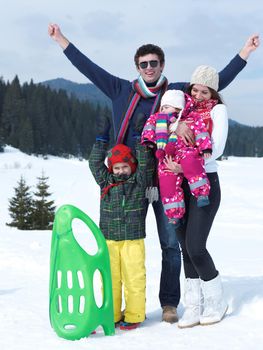 Winter playing, fun, snow and family portrait  sledding at winter time