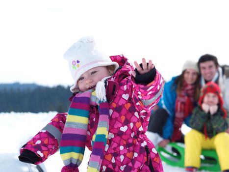 Winter playing, fun, snow and family portrait  sledding at winter time