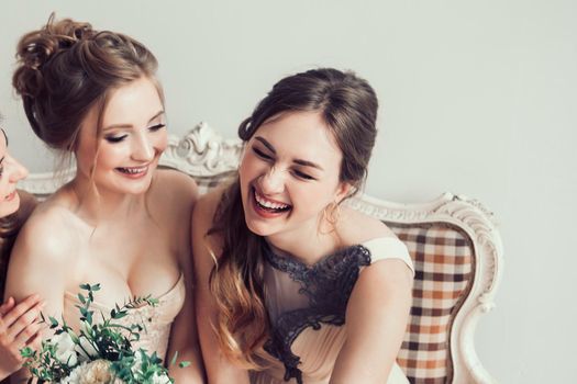 cheerful bride with her girlfriends sitting together . photo with copy space