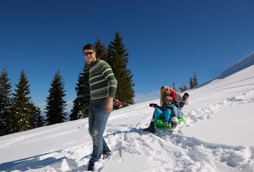 Winter season. Happy family having fun on fresh snow on vacation.