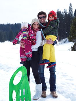 Winter playing, fun, snow and family portrait  sledding at winter time