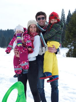 Winter playing, fun, snow and family portrait  sledding at winter time