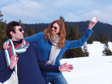 romantic winter  scene, happy young couple having fun on fresh show on winter vacatio, mountain nature landscape